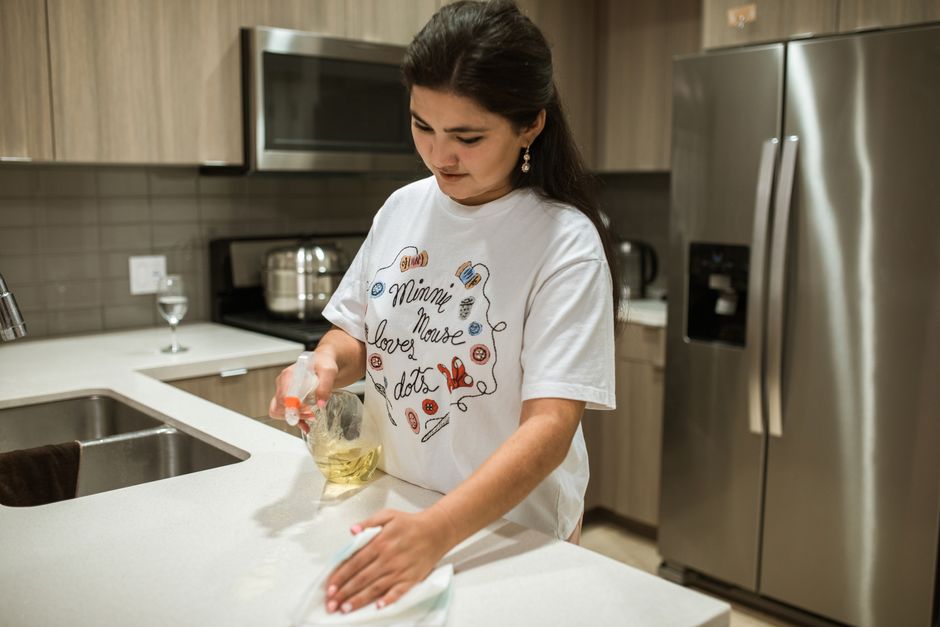 Professional wiping a kitchen counter during a deep cleaning